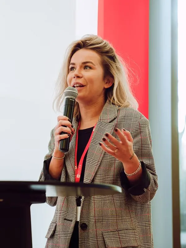An Antler founder presenting with a microphone at an event