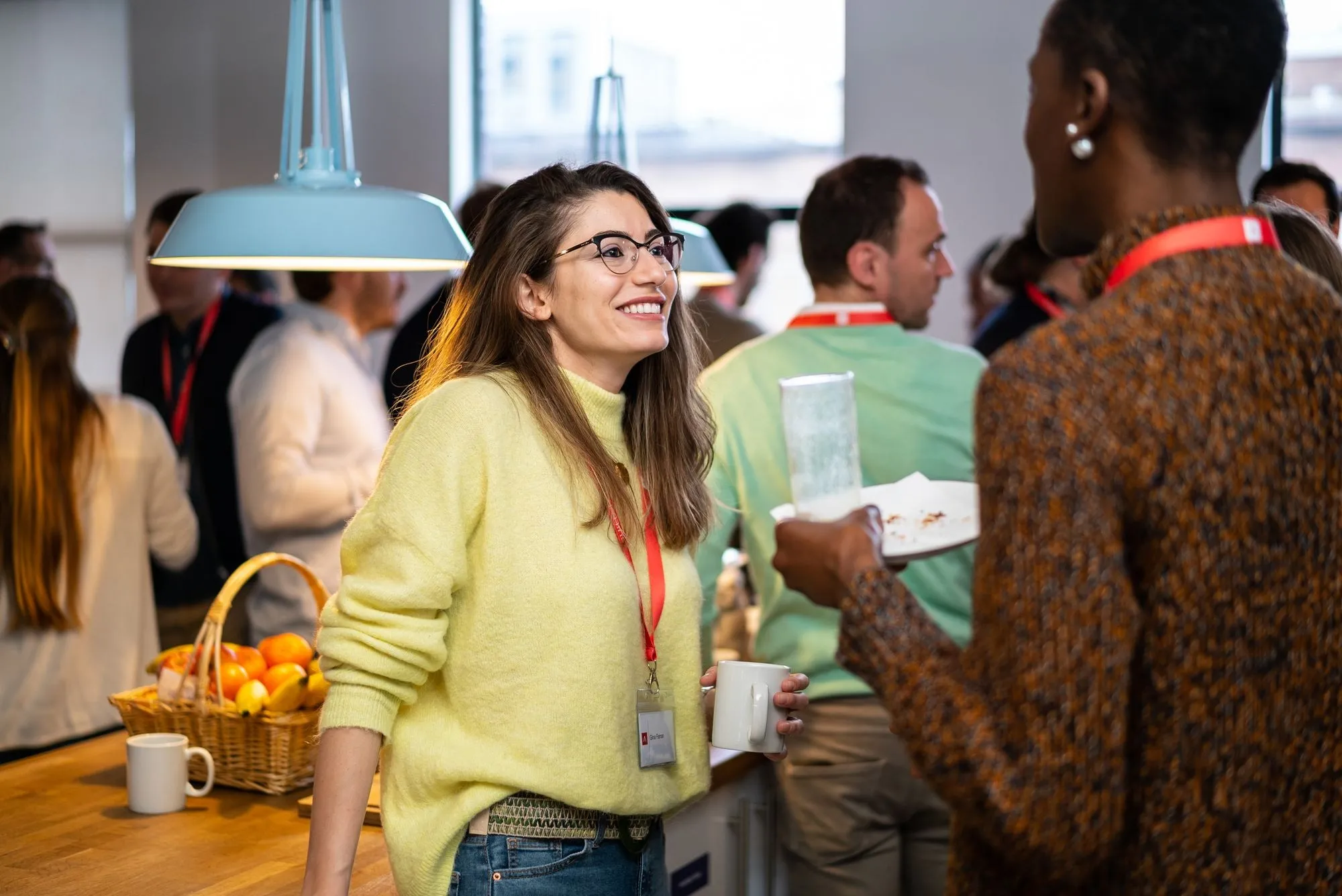 Founders talking over coffee at an Antler UK event, one smiling mid-conversation